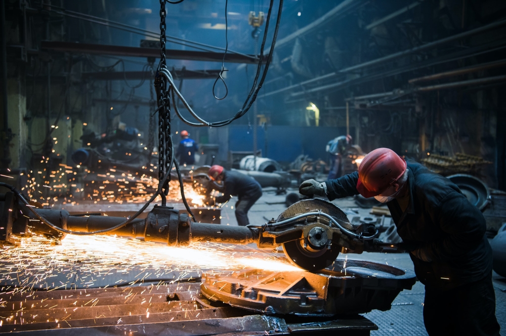 Welder used grinding stone on steel in factory with sparks 1024x681